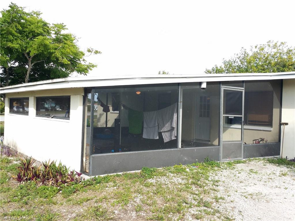 Image 2: Rear view of house with a sunroom