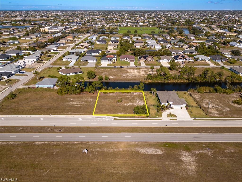 Image 4: Aerial view of residential area with property boundaries highlighted and a large body of water