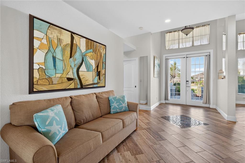 Image 3: Foyer with french doors, wood finished floors, and a high ceiling