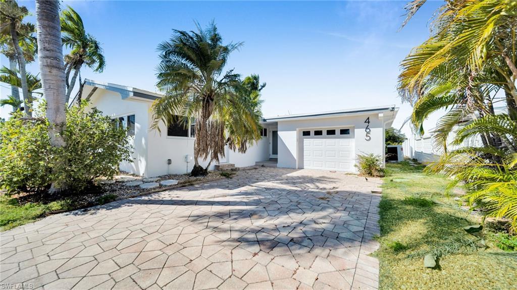 Image 4: View of front of property featuring stucco siding, decorative driveway, and an attached garage