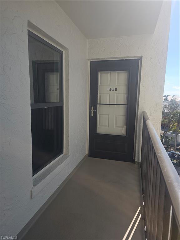 Image 4: Entrance to property with freshly painted stucco exterior and views towards the beach, gulf and surrounding area from front balcony