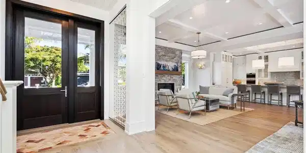 Image 4: Foyer with a stone fireplace, beamed ceiling, coffered ceiling, wooden ceiling, and light wood-type flooring