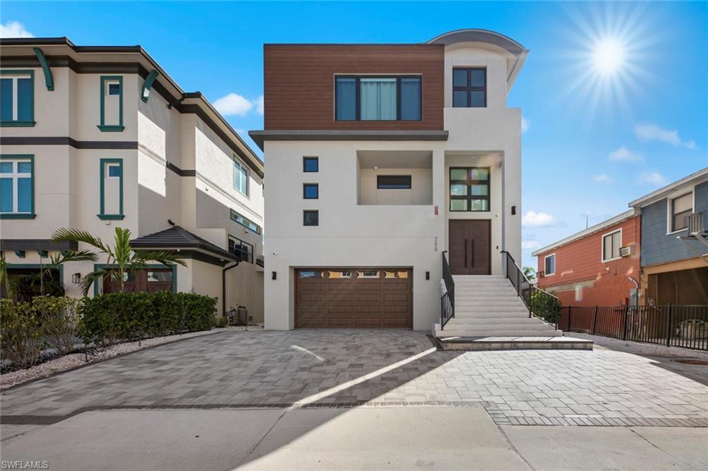 Image 1: View of front of property featuring a garage