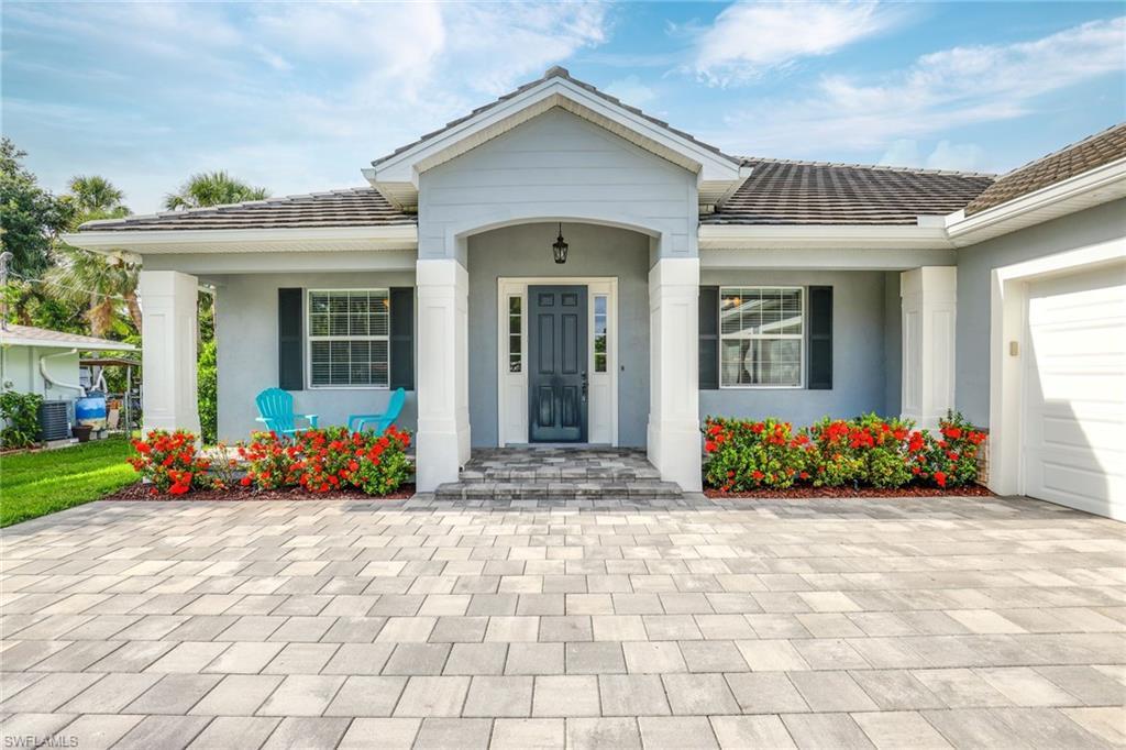 Image 1: View of front of house with a garage