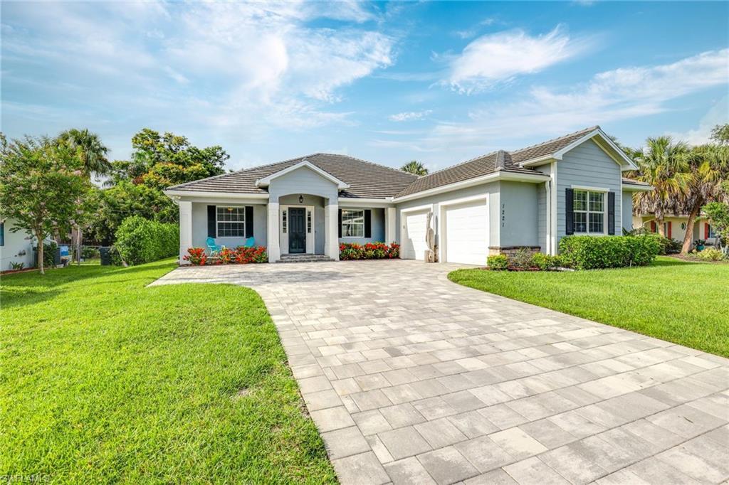 Image 3: Ranch-style home featuring a front yard and a garage