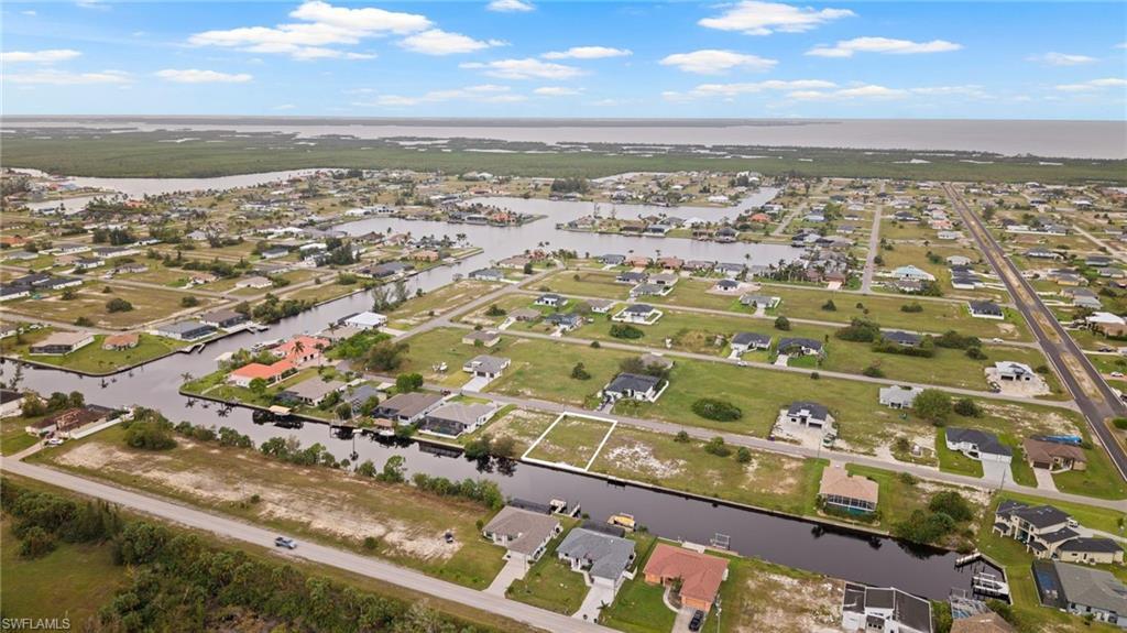 Image 1: Bird's eye view of surrounding canals and homes