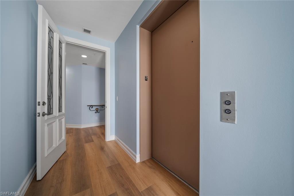 Image 3: Hall featuring elevator and light hardwood / wood-style floors