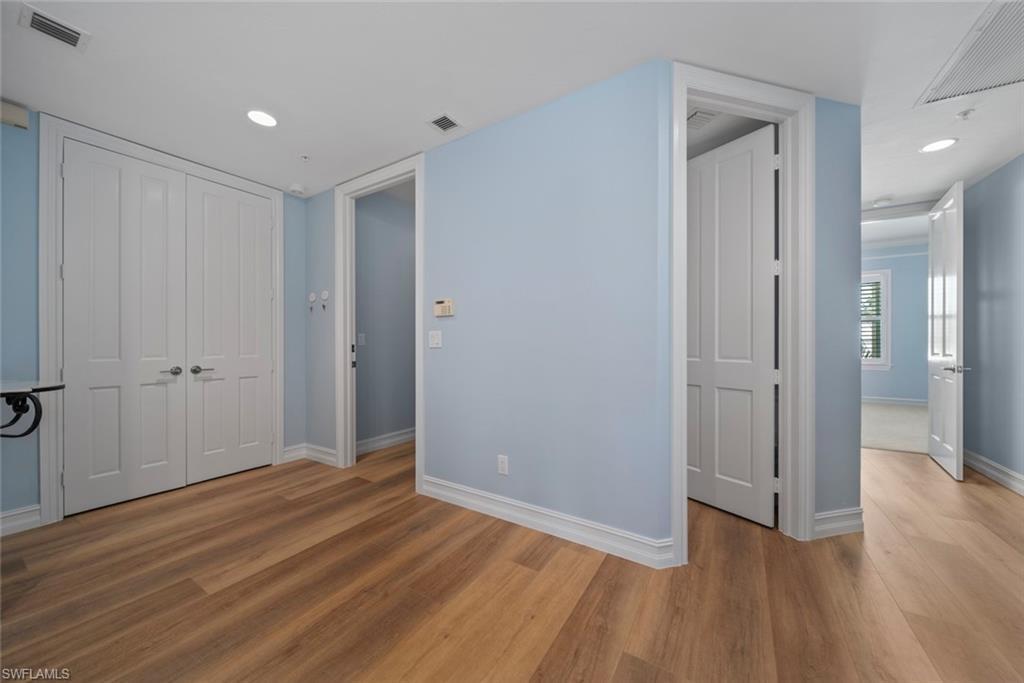 Image 4: Unfurnished bedroom featuring hardwood / wood-style flooring and a closet