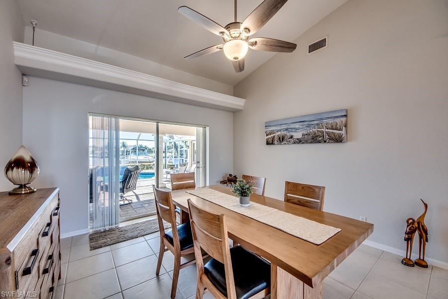 Image 4: Tiled dining area featuring ceiling fan and lofted ceiling