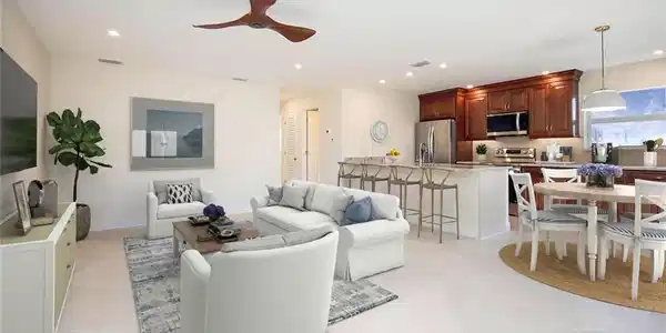 Image 3: Living room featuring light tile patterned floors and ceiling fan