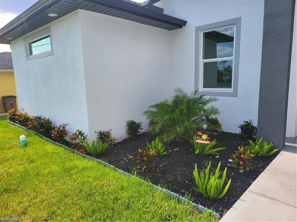 Image 3: View of property exterior with a lawn