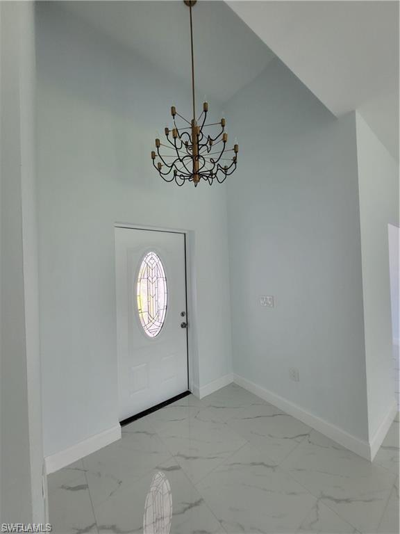 Image 4: Entrance foyer featuring a notable chandelier
