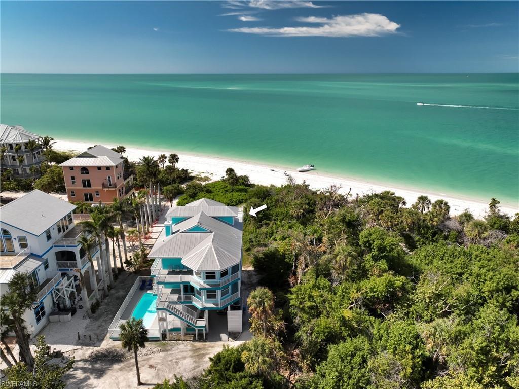 Image 3: Aerial view featuring a water view and a view of the beach