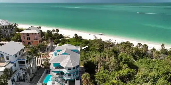 Image 3: Aerial view featuring a water view and a view of the beach