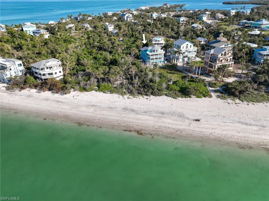 Image 4: Aerial view with a water view and a beach view