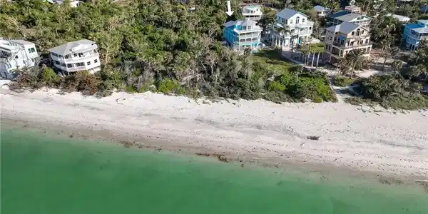 Image 4: Aerial view with a water view and a beach view