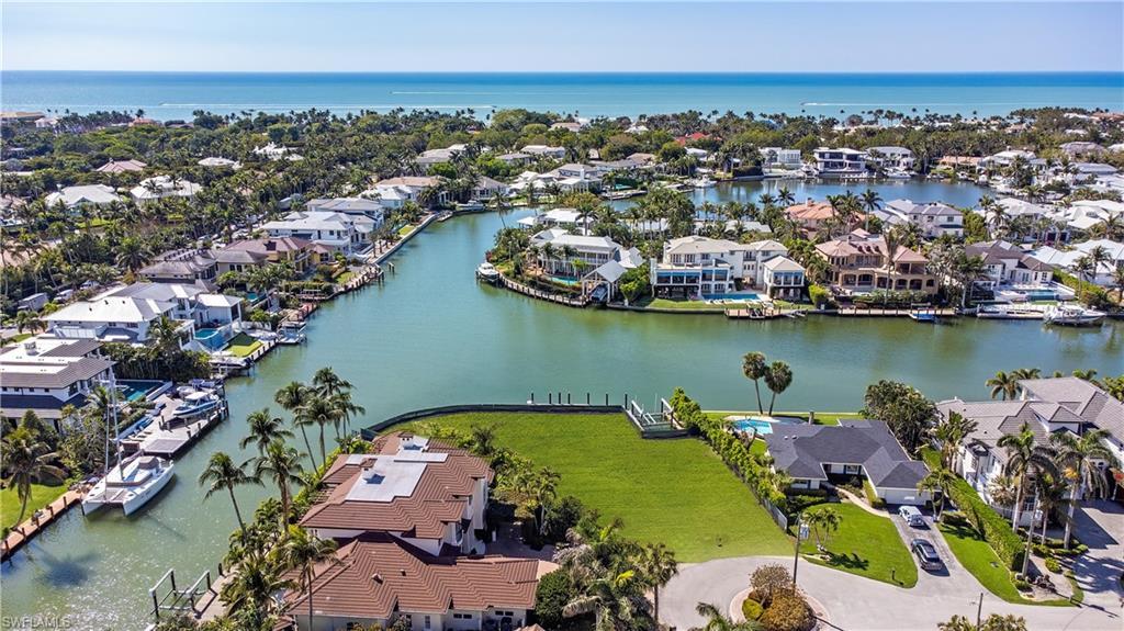 Image 2: Aerial perspective of suburban area with a nearby body of water