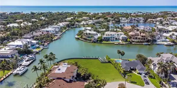 Image 2: Aerial perspective of suburban area with a nearby body of water
