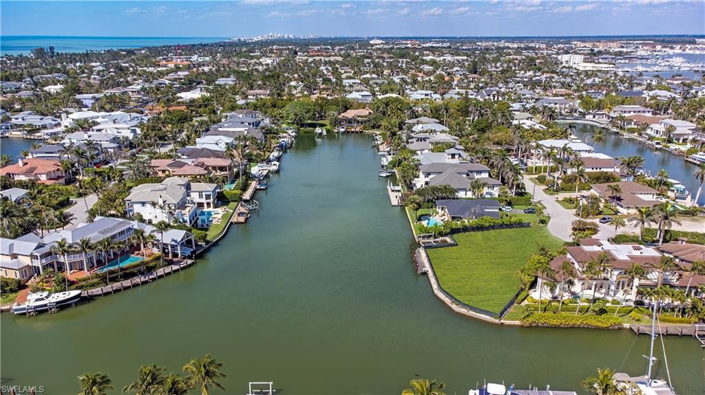 Image 3: Aerial view of residential area with a nearby body of water