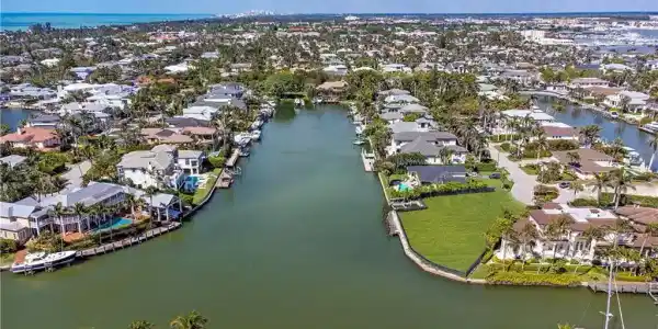 Image 3: Aerial view of residential area with a nearby body of water