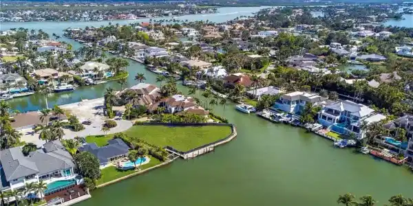 Image 4: Aerial view of residential area featuring a nearby body of water