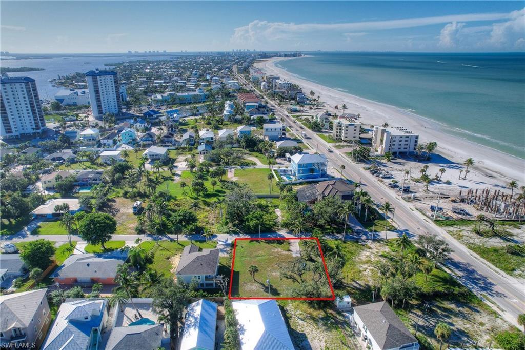 Image 1: Aerial overview of property's location with waterfront with a beach and property boundaries highlighted