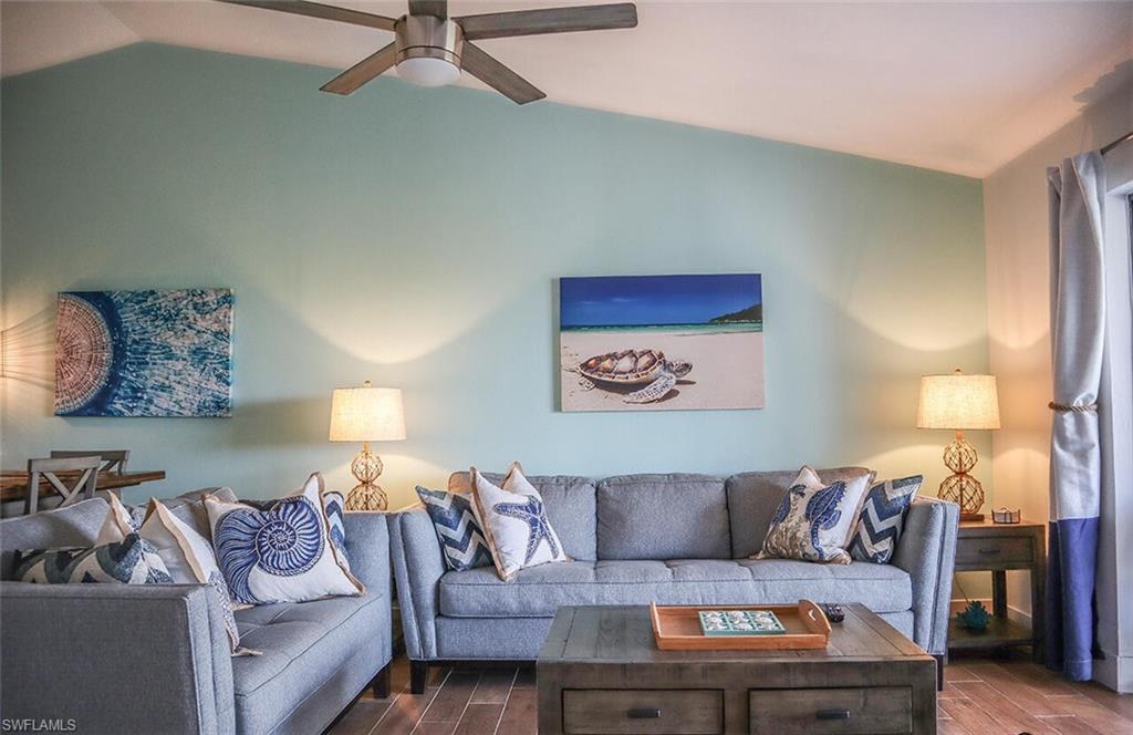 Image 3: Living room featuring ceiling fan, dark wood-style floors, and vaulted ceiling