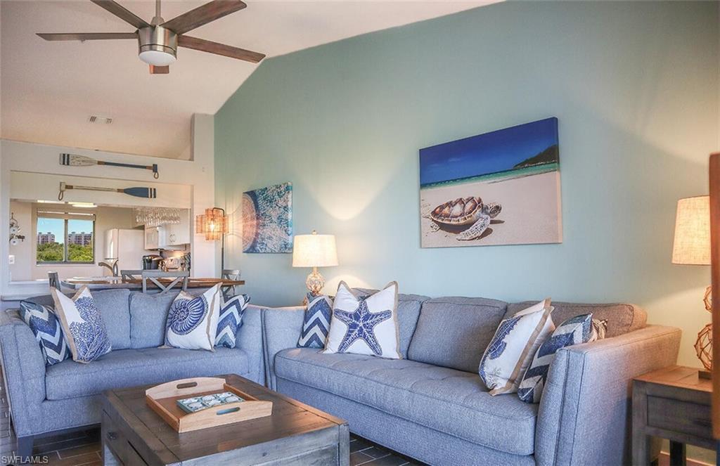 Image 4: Living area with ceiling fan, wood finished floors, lofted ceiling, and visible vents