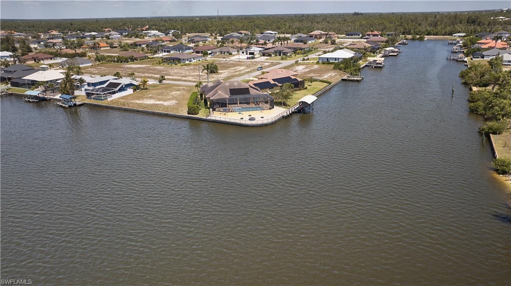 Image 1: Bird's eye view featuring a water view and a residential view