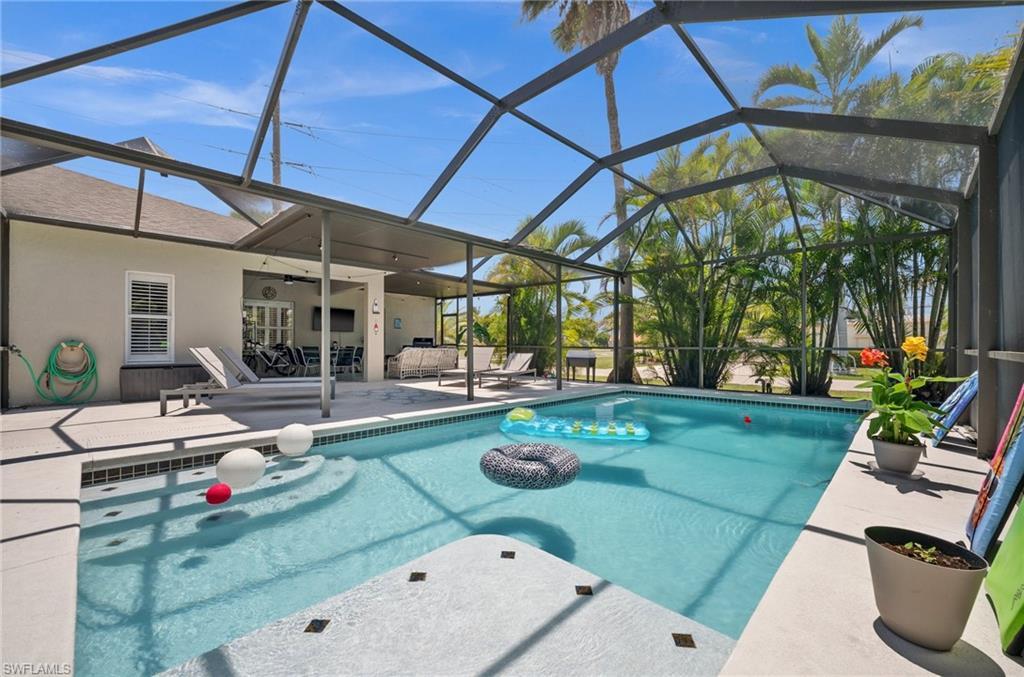 Image 2: Swimming pool featuring a patio area, a ceiling fan, a lanai, and an outdoor hangout area