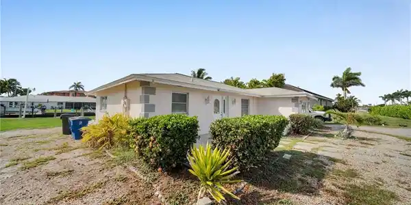 Image 3: View of property exterior with stucco siding