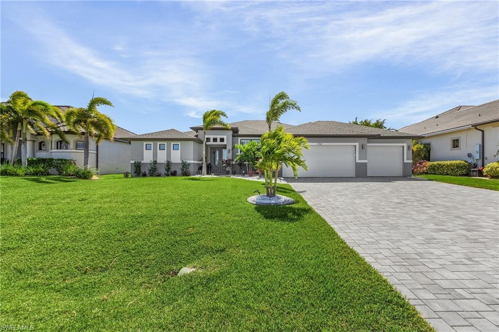 Image 3: View of front of property featuring a garage and a front lawn