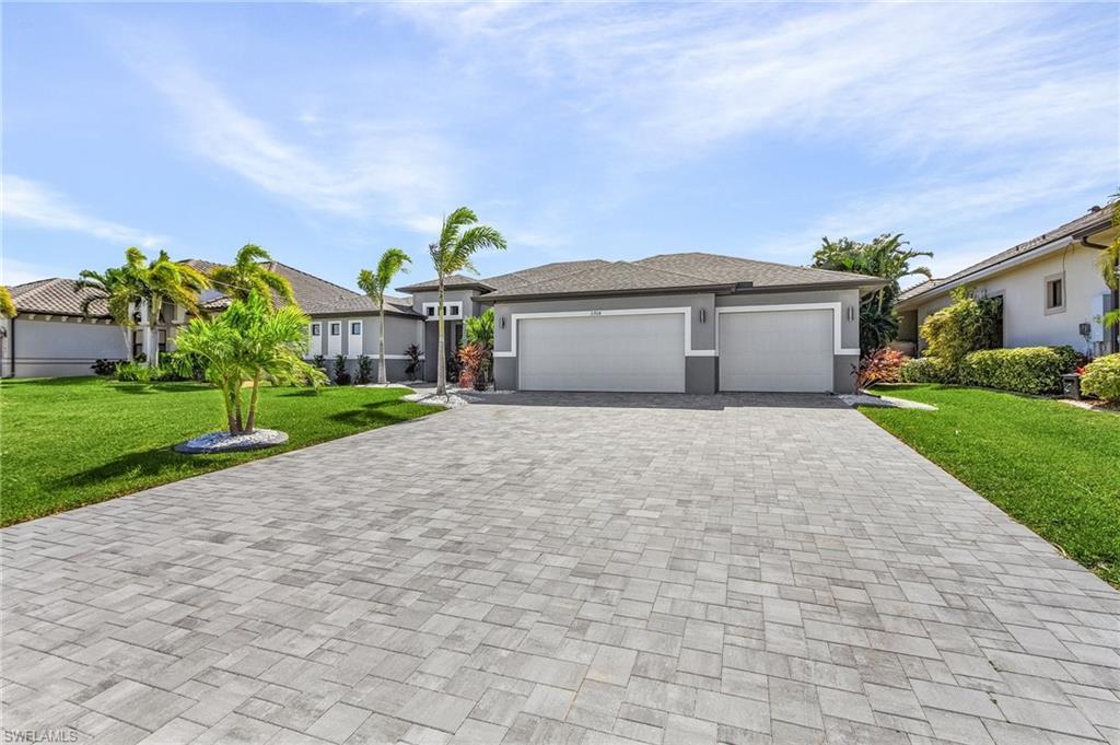 Image 4: View of front facade featuring a front yard and a garage