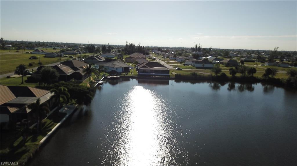 Image 3: Aerial view of residential area with a nearby body of water