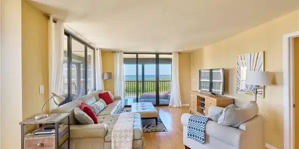 Image 4: Living area featuring wood finished floors and a wall of windows