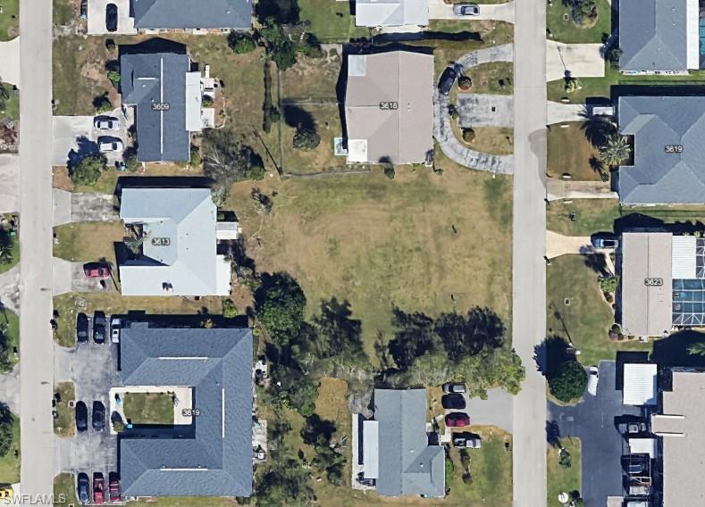 Image 1: Aerial overview of property's location with nearby suburban area