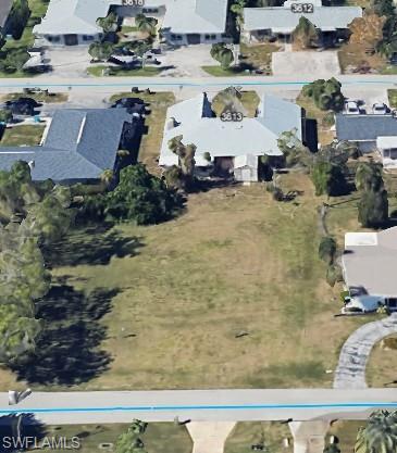 Image 3: Aerial view of property and surrounding area featuring nearby suburban area
