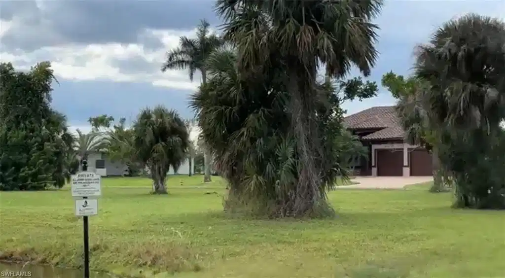 Image 1: View of property's community featuring a yard