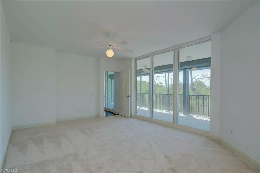 Image 1: Great room featuring light colored carpet, floor to ceiling windows, and a ceiling fan