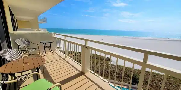 Image 2: Balcony with view of water and beach and view of pool area