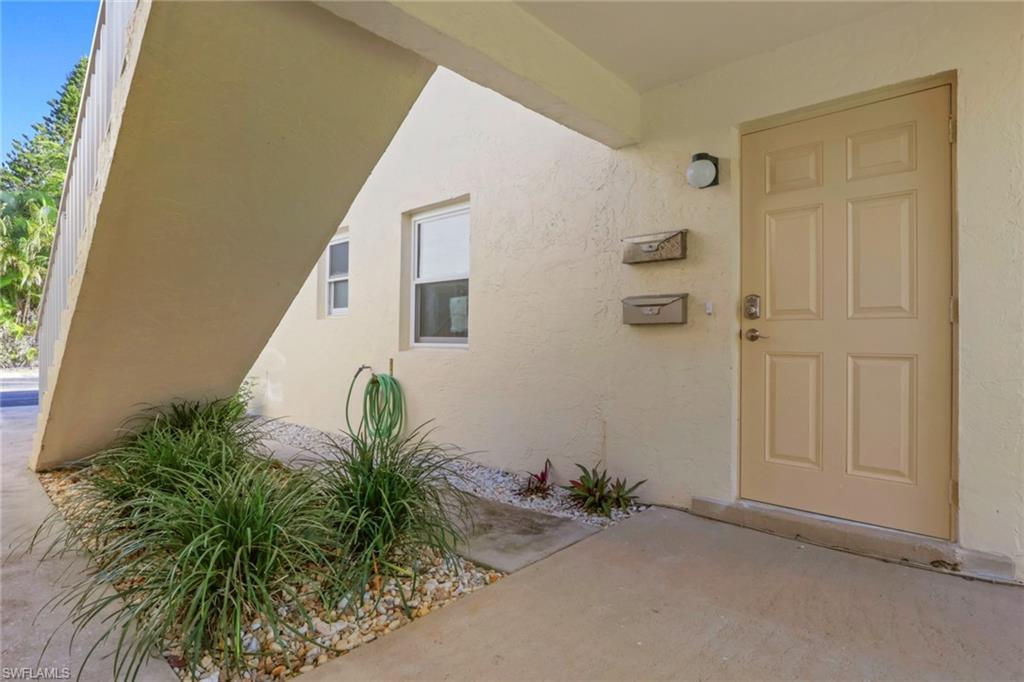 Image 3: Property entrance with stucco siding