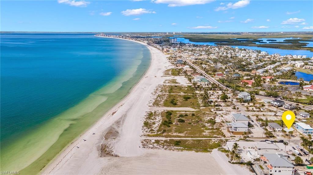 Image 1: Aerial view featuring a beach view and a water viewVirtually enhanced