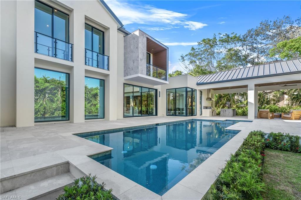 Image 4: Swimming pool with a patio and a balcony