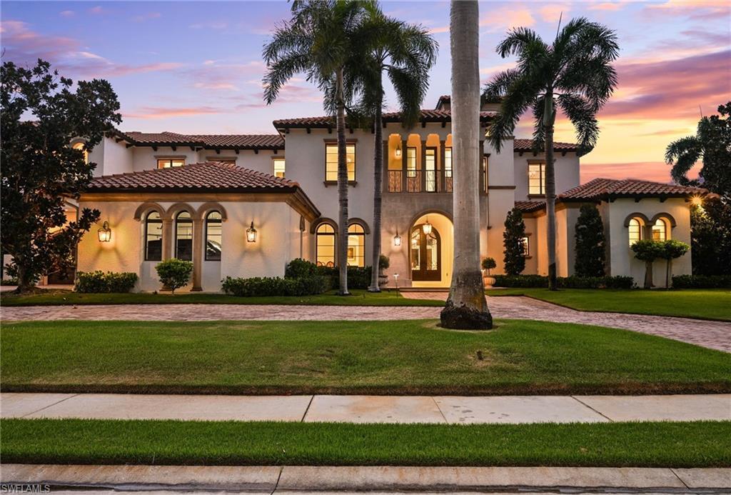 Image 2: Mediterranean / spanish home featuring a front yard, stucco siding, and driveway