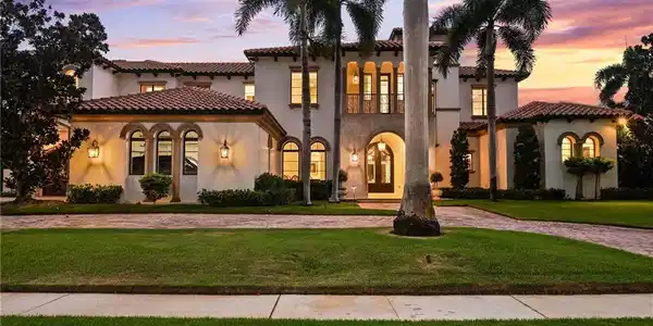 Image 2: Mediterranean / spanish home featuring a front yard, stucco siding, and driveway