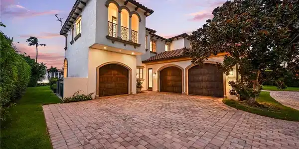 Image 4: Mediterranean / spanish-style home featuring decorative driveway, a balcony, stucco siding, and a yard