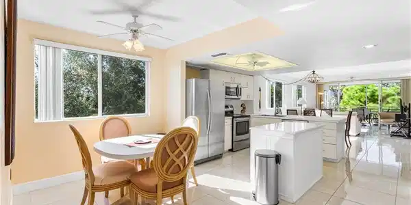 Image 2: From the entry, relish the openness and brightness of the space, with south windows, light cabinetry and bright ceramic tile floors.