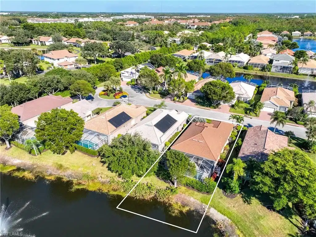 Image 1: Aerial view of residential area featuring a nearby body of water and property boundaries highlighted