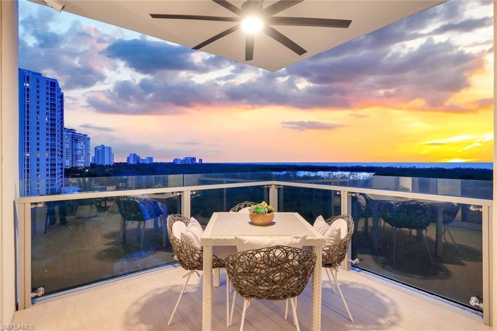 Image 2: Balcony at dusk featuring outdoor dining space and a city view