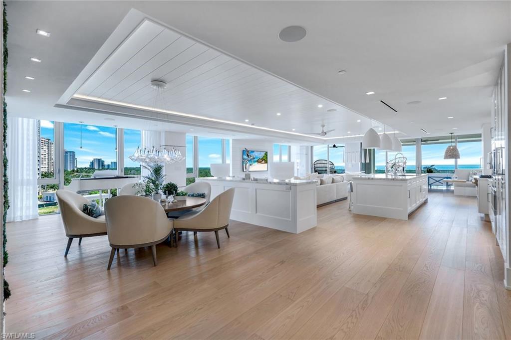 Image 4: Dining room featuring expansive windows, light wood-type flooring, and recessed lighting